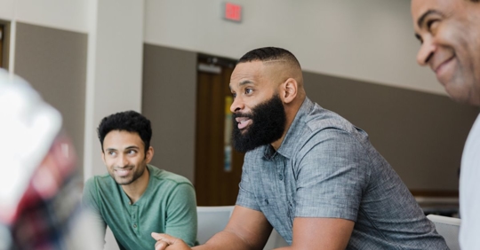 Men talking in a group setting